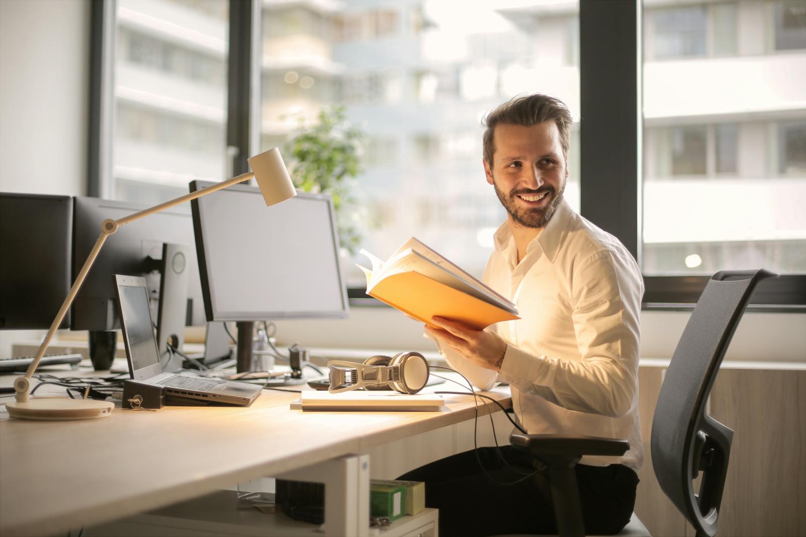 Photo of Man Holding a Book, business owners policy